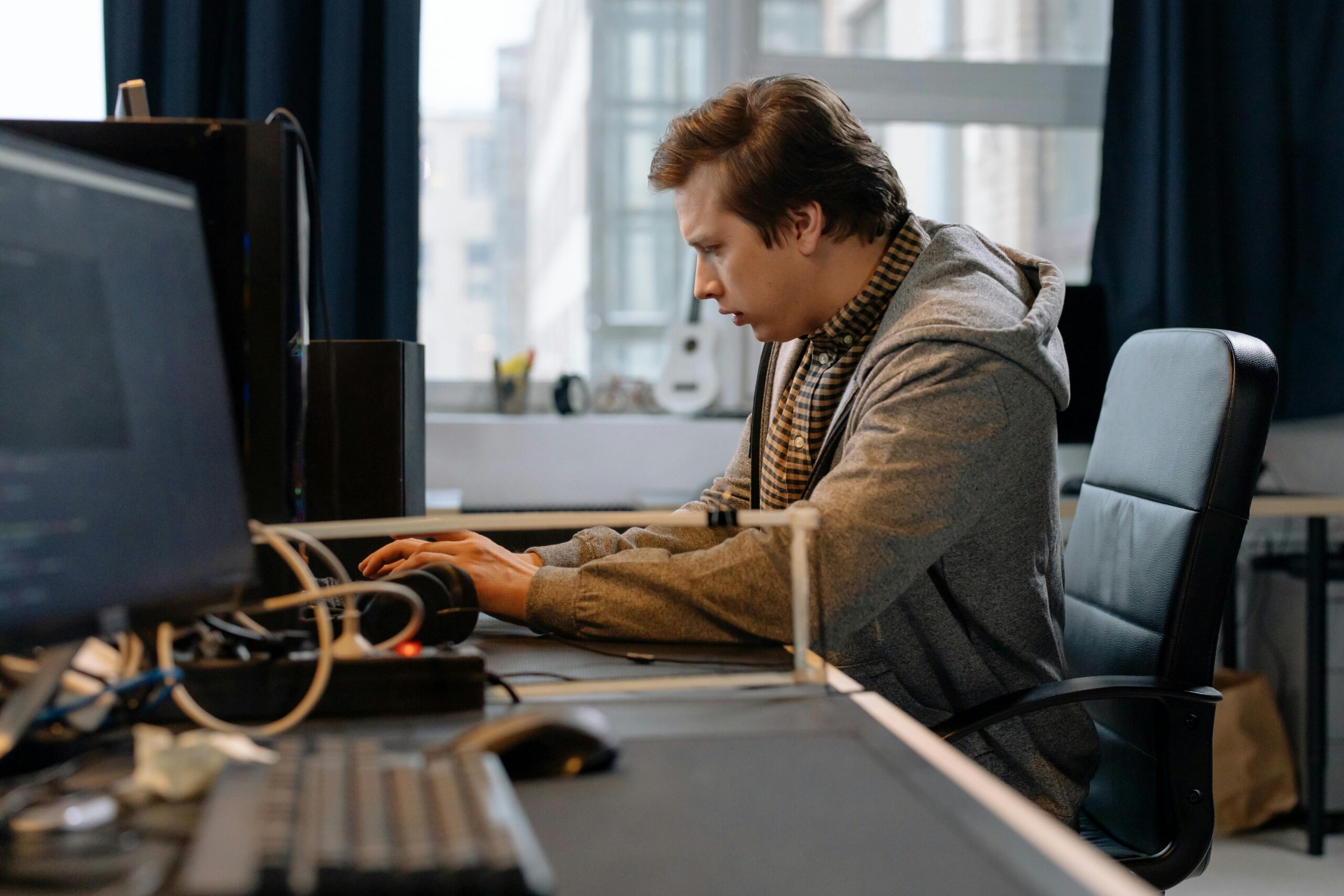 Person working at a desktop computer in an office.