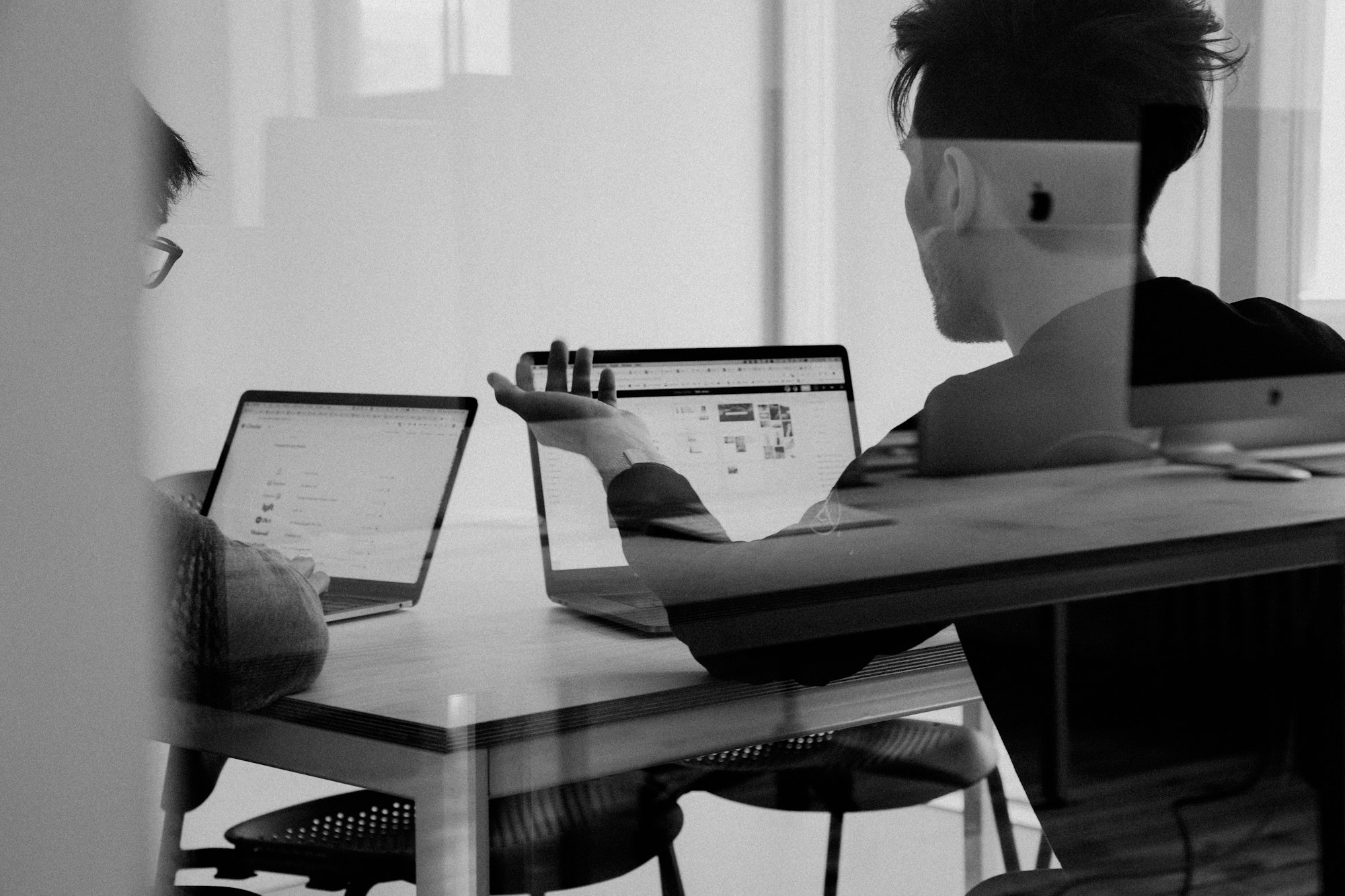 A business team talking through work in an office that depends on reliable connectivity.