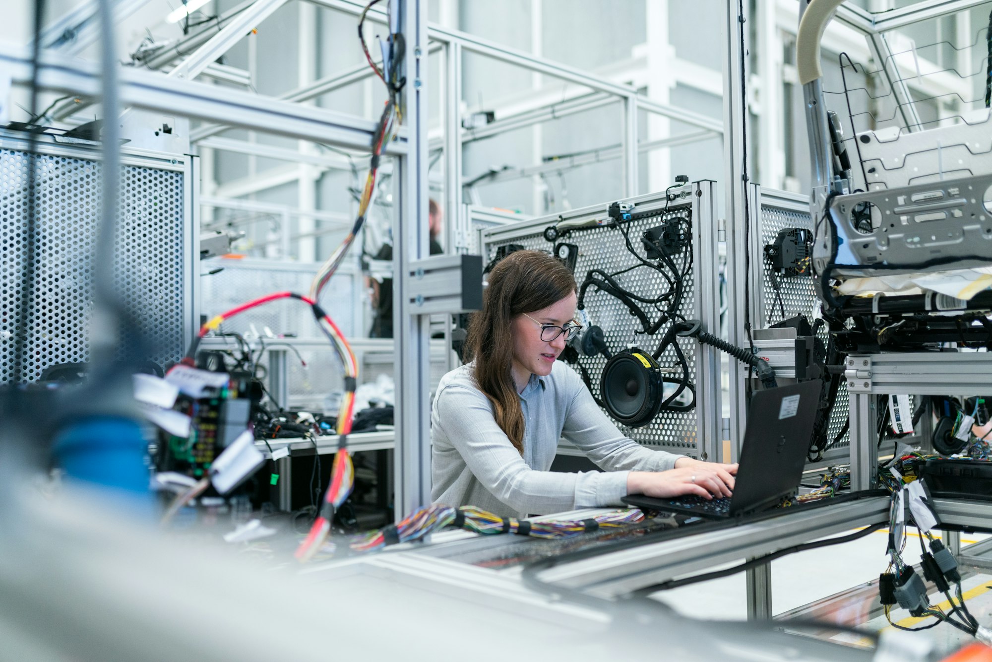 Person reviewing systems on a laptop in a practical workplace.