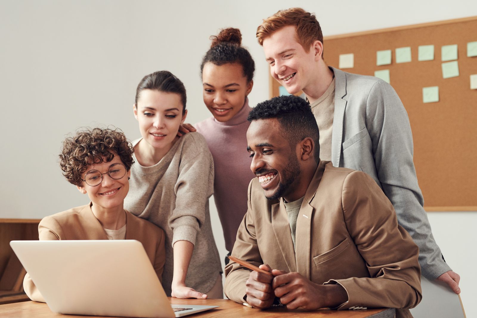 Small team in a meeting around a laptop