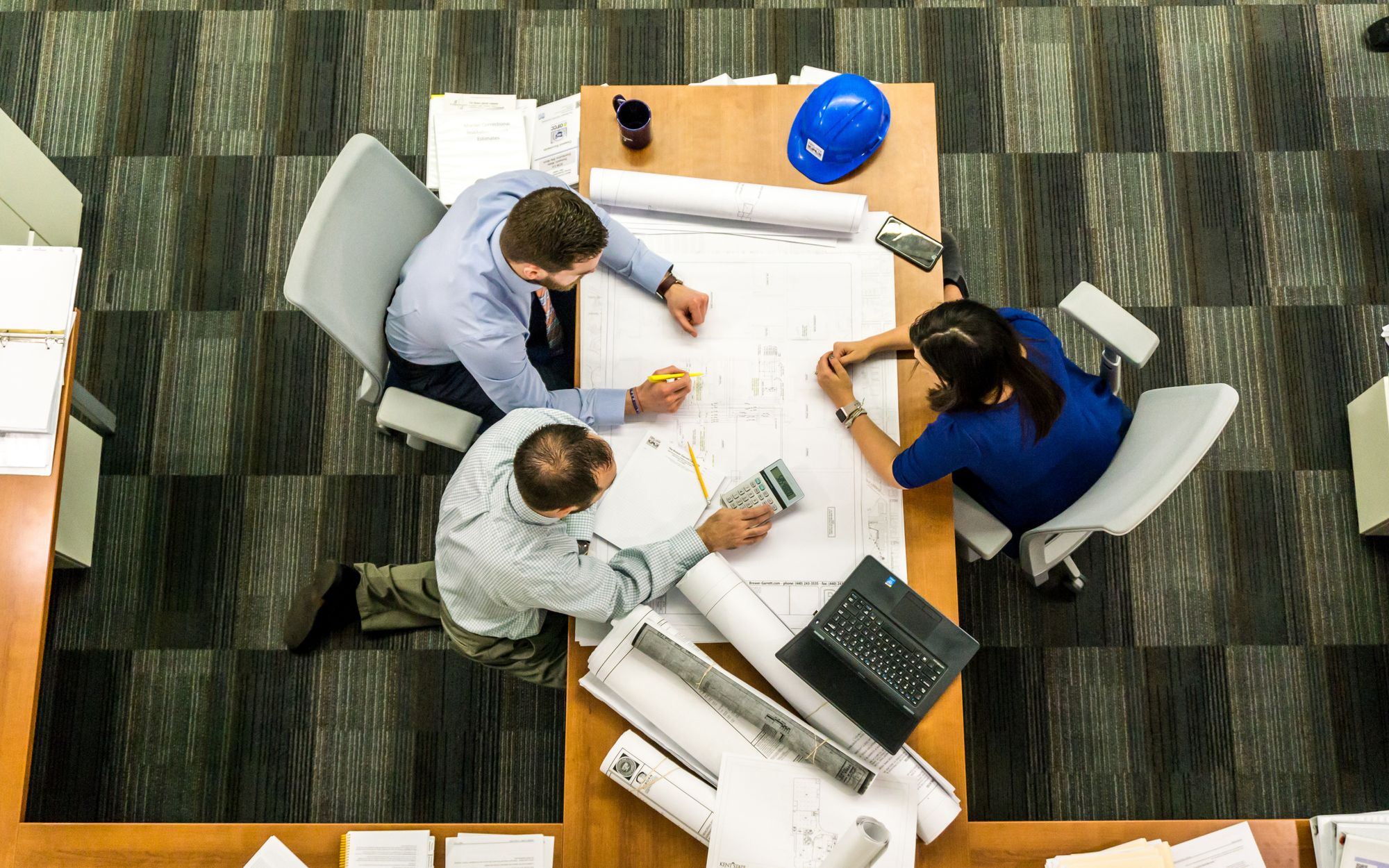 People working across an open office where wireless coverage has to reach more than one desk.