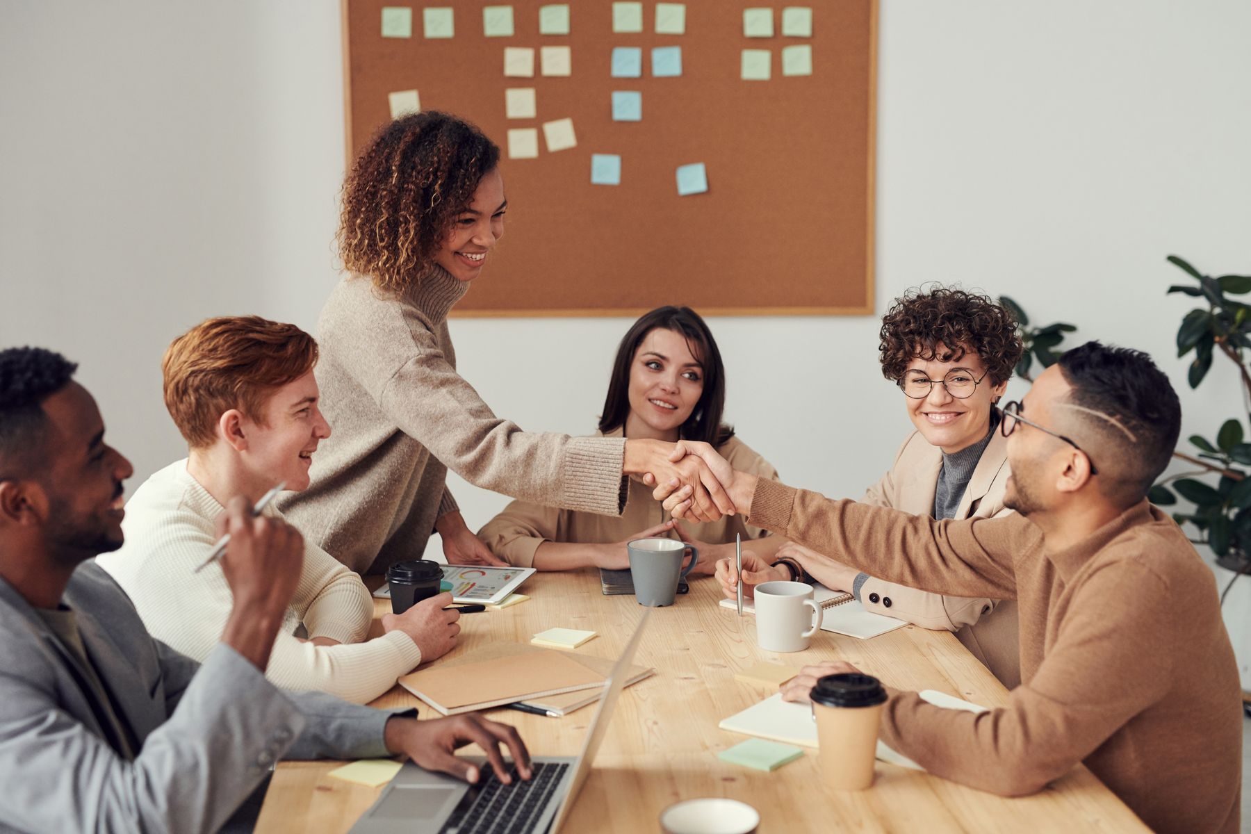 Small business team talking through a problem around a table.